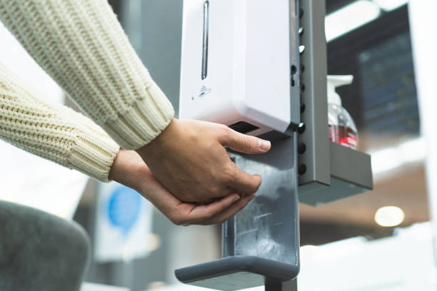 istock Cleaning, washing hands using automatic sanitizer dispenser concept. Today people lifestyle concept. 1359167254