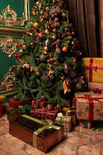 istock a beautiful decorated Christmas tree and large beautiful boxes with gifts in different beautiful packaging with beautiful ribbons under it 1359167271