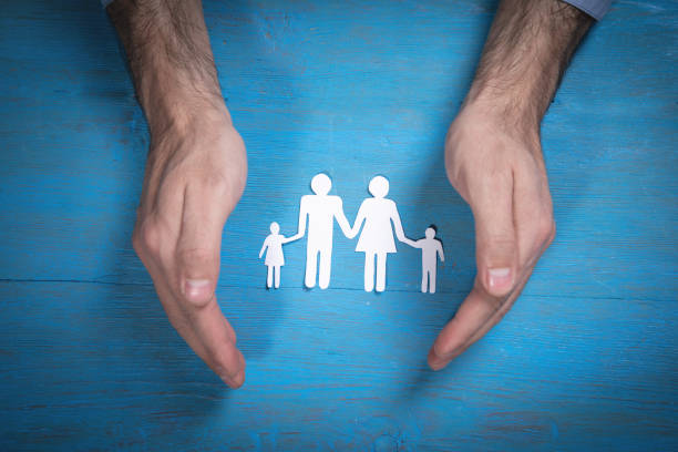 istock Human hands showing paper cut family. 1359167633