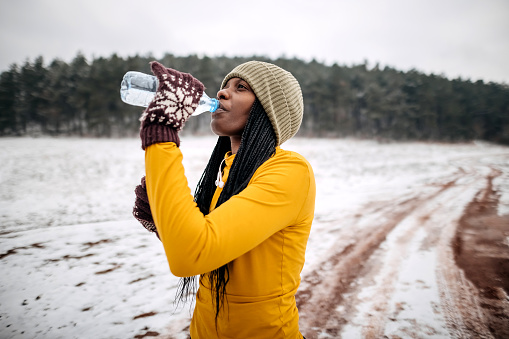Woman drinks water after training
