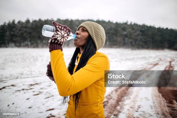 Woman Drinks Water After Training Stock Photo - Download Image Now - Winter, Drinking Water, Outdoors