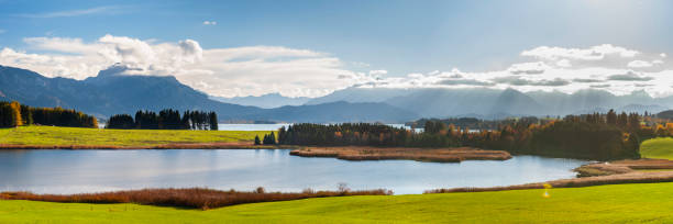 istock panoramic view to alps mountain range and lake Forggensee in Bavaria 1359168961