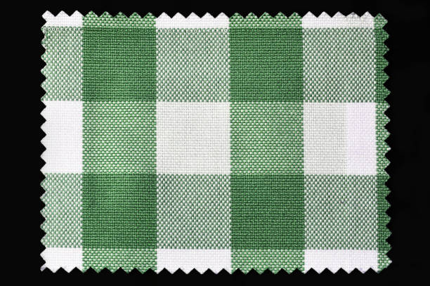 Green and white checkered fabric sample isolated on black background