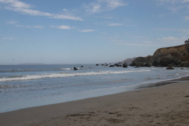 istock Coastline view with beach and rocks 1359173308