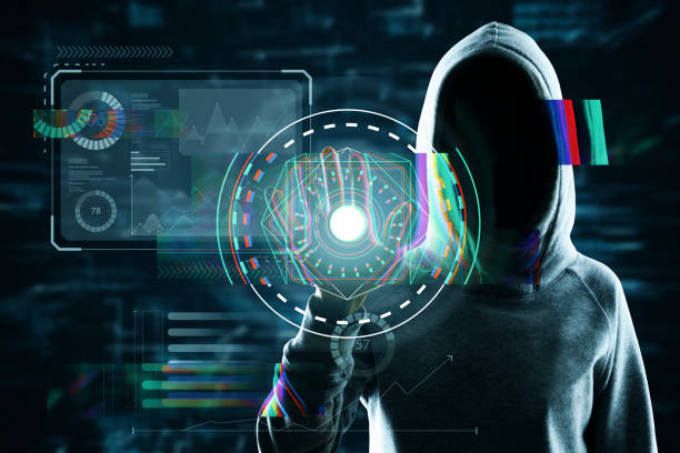 istock Hacker in hoodie using scanner on abstract glowing business hologram interface on dark background. Security, hacking, autorization and biometrics concept. Double exposure. 1359173351