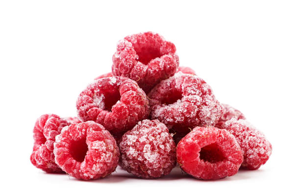 Heap frozen raspberries on a white background. Isolated