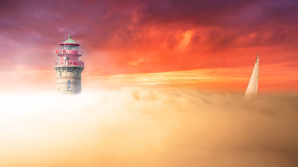 istock A sailboat passes a lighthouse on a foggy coastline 1359174391