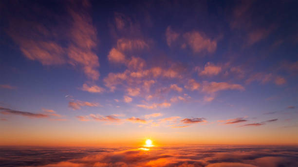 istock Beautiful photo of view on setting sun above the clouds 1359174885