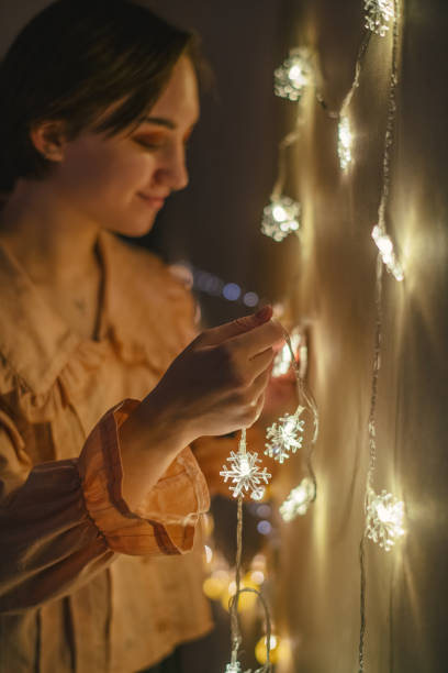 istock Young woman decorating home for Christmas 1359175052