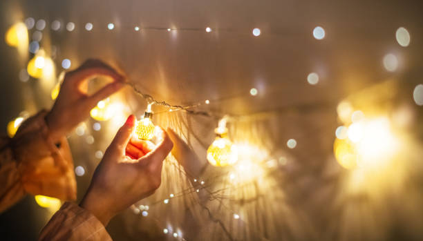 istock Young woman decorating home for Christmas 1359175090