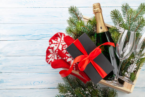 istock Christmas gift box with champagne bottle 1359176637