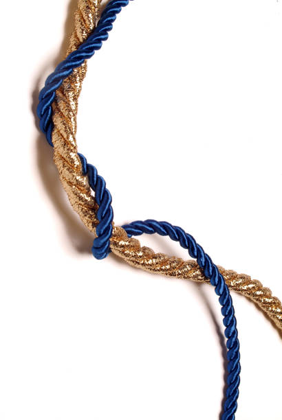 istock golden rope woven with blue silk rope - white background - vertical 1359181367