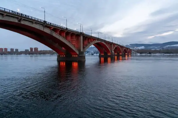 Communal Bridge (1961) with night illumination across the Yenisei River in the city of Krasnoyarsk. Russia.
