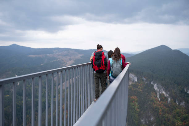 Sky Bridge 721 - the Worlds longest suspension footbridge with people walking across it against a clear blue sky with white clouds. Czechia