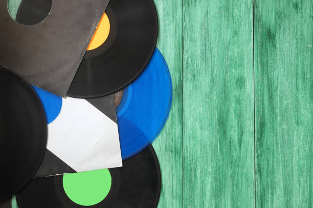 Vinyl record on a green background. Retro style. Top view.