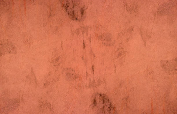 istock Red concrete wall surface with scattered black spots for background 1359186376