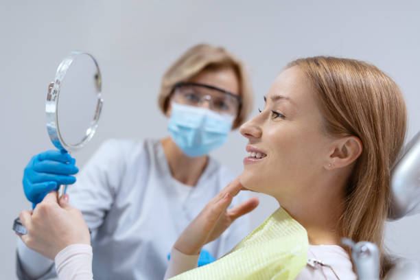 istock Patient looks in mirror at professional dentist appointment 1359187553