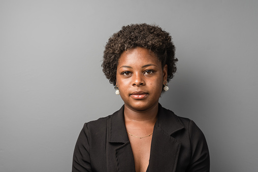Portrait of young serious black woman in studio