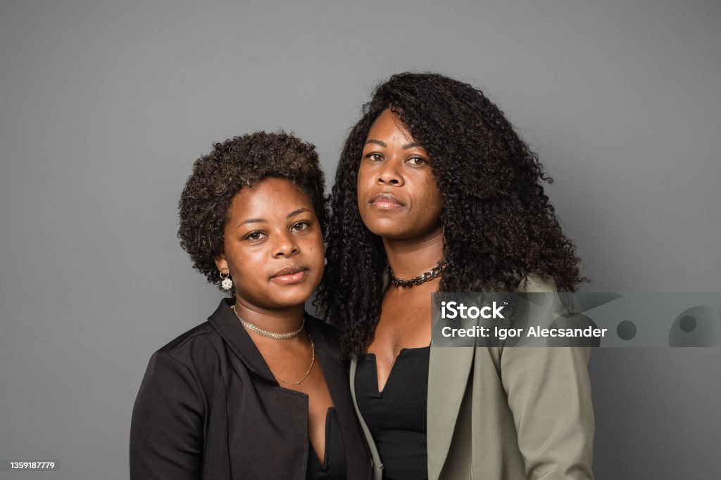 Portrait of serious mother and daughter in studio 18-19 Years Stock Photo
