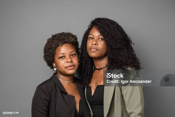 Portrait Of Serious Mother And Daughter In Studio Stock Photo - Download Image Now - 18-19 Years, 25-29 Years, 35-39 Years