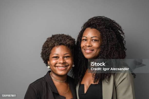 Daughter And Mother Portrait On Gray Background Stock Photo - Download Image Now - Mother, Two People, Studio Shot