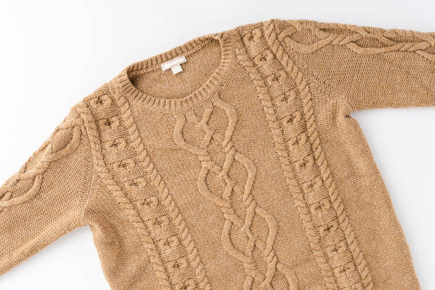 istock Beige knitted sweater isolated on white background. Flat lay. Top view 1359188516