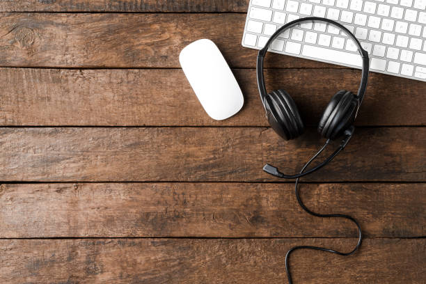 istock Call center desktop with headphones and computer. Top view 1359189263