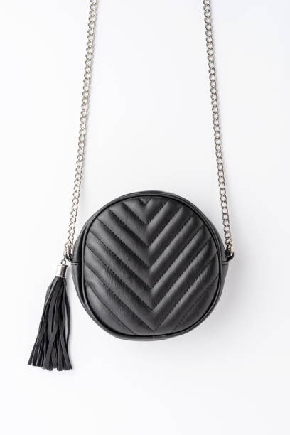istock Black elegant shoulder bag isolated on white background. Flat lay 1359189296