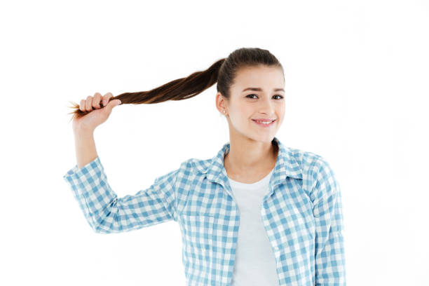 istock Young girl playing with her hair 1359190410