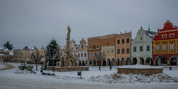 Square in old Telc town in winter dark cold morning with very old houses