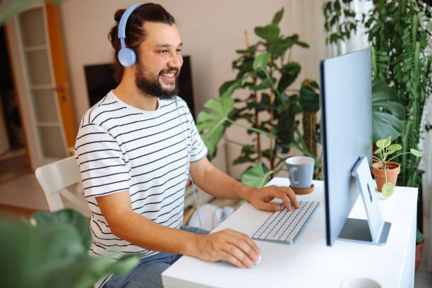 istock Young man working at home in the evening 1359192343