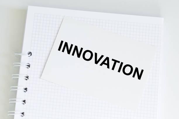 istock Innovation text on a card next to a puffed notebook on the table, business concept 1359192929