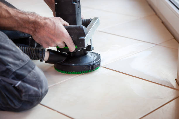 istock Man is working with an electric flooring grinding machine. Tiles floor surface grinding by grinder machine for a smooth base. 1359193244
