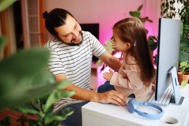 istock Father and daughter working together at home 1359194684