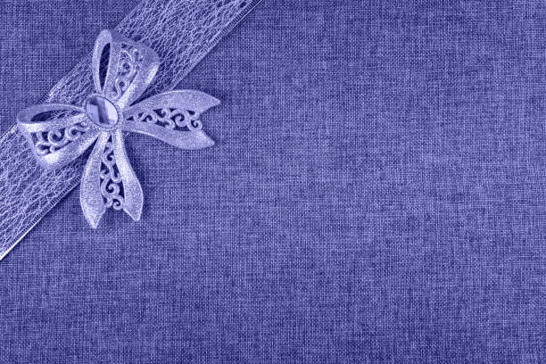 Macro photo of a Christmas chiffon bow. Ribbon fabric close up. Mesh