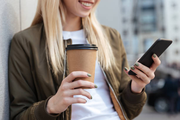istock Cropped image of blonde woman using smartphone 1359195630