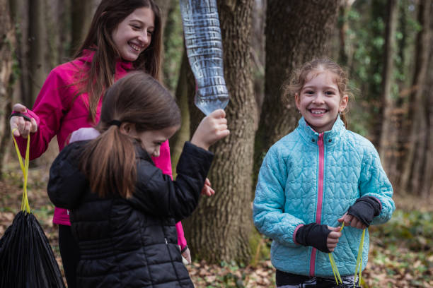 istock Cheerful children laughing when collecting plastic waste in the forest 1359197027
