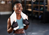 istock Shot of a sporty young woman posing with a towel around her neck at gym 1359197283