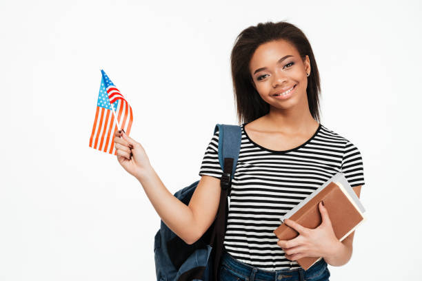 istock Girl student with backpack holding books and US flag 1359197389
