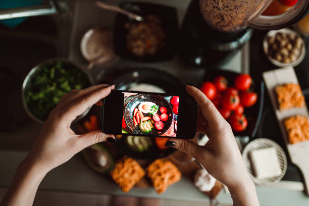 istock Woman photographing with a smartphone fried eggs at home 1359201944