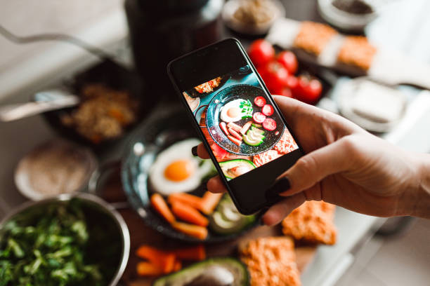 istock Woman photographing with a smartphone fried eggs at home 1359201967