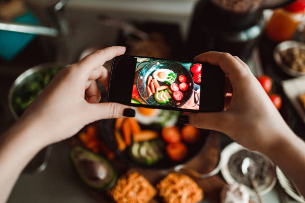 istock Woman photographing with a smartphone fried eggs at home 1359202255