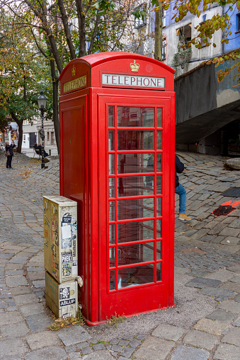 Vienna, Austria - October 2021: Red telephone box at Hundertwasser house