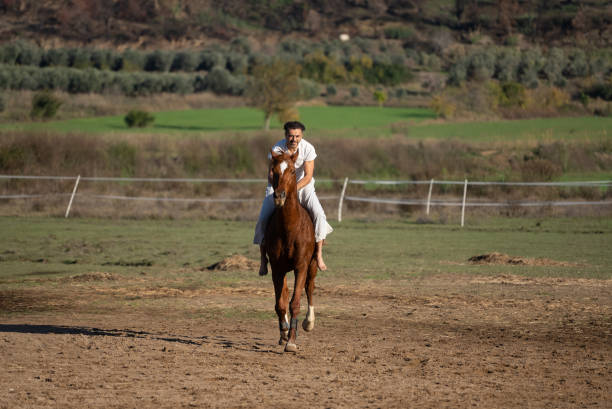 istock Man enjoying horseback riding in farm 1359211503