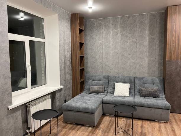 istock modern living room with gray sofa, gray laminate on the wall 1359211688