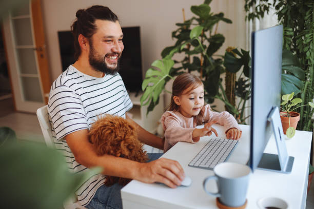 istock Father and daughter working together at home 1359212223