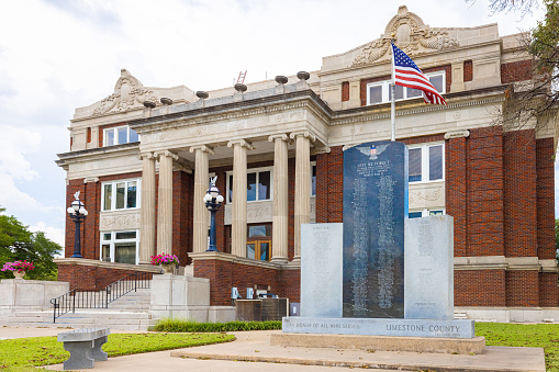 Groesbeck, Texas, USA - August 17, 2021: The Limestone County Courthouse and its War Memorial