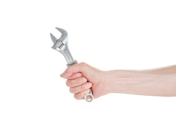 istock A cap wrench, a split wrench in the hand of a worker, a builder, isolated on a white 1359218761