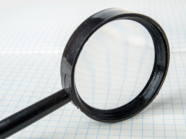 istock Magnifying glass, lens, loupe, close-up, selective focus, reading small print 1359221361