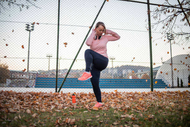 istock Young sportswoman warming up before training outdoors 1359222878